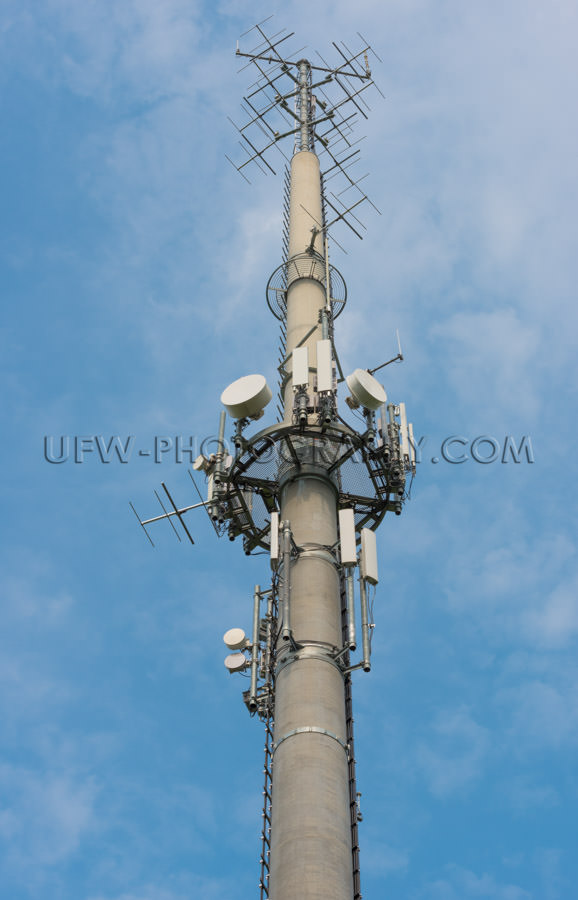 Communication antenna concrete tower mobile phone network Stock 