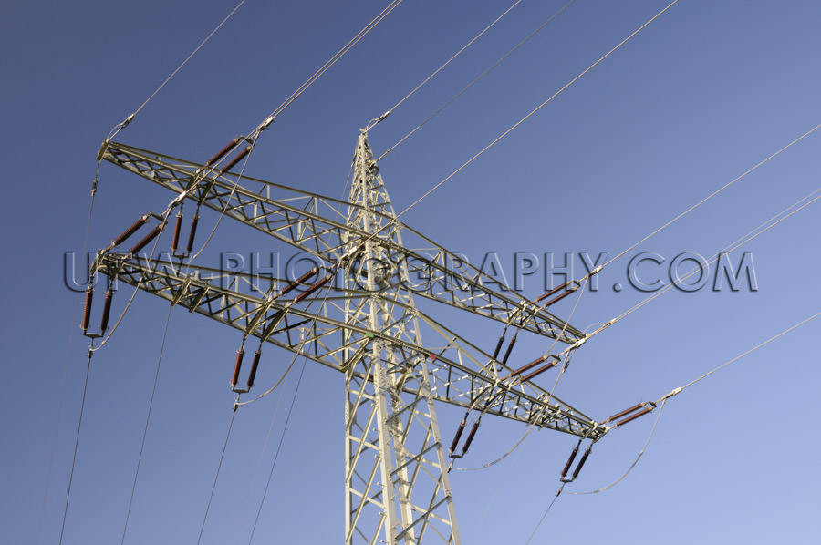 Power line and electricity Pylon, close up, deep blue sky - Stoc