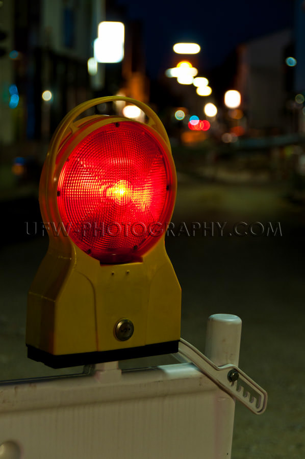 Red warning light at a road construction site, night shot - Stoc