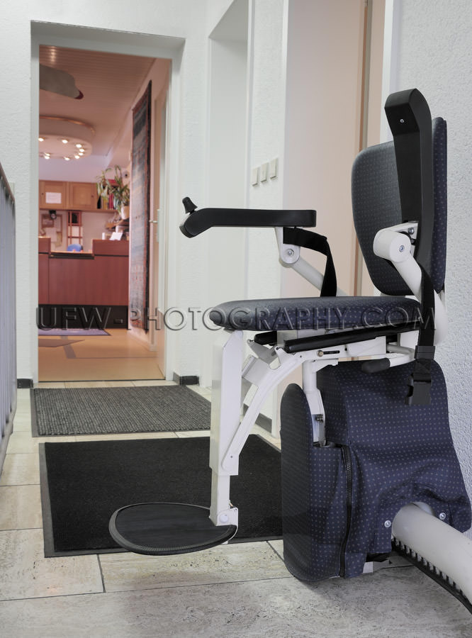 Stairlift elevator for handicapped persons chair in upstairs pos