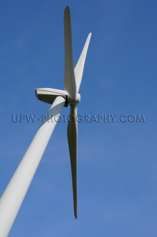 Wind turbine close up against clear deep blue sky Stock Image