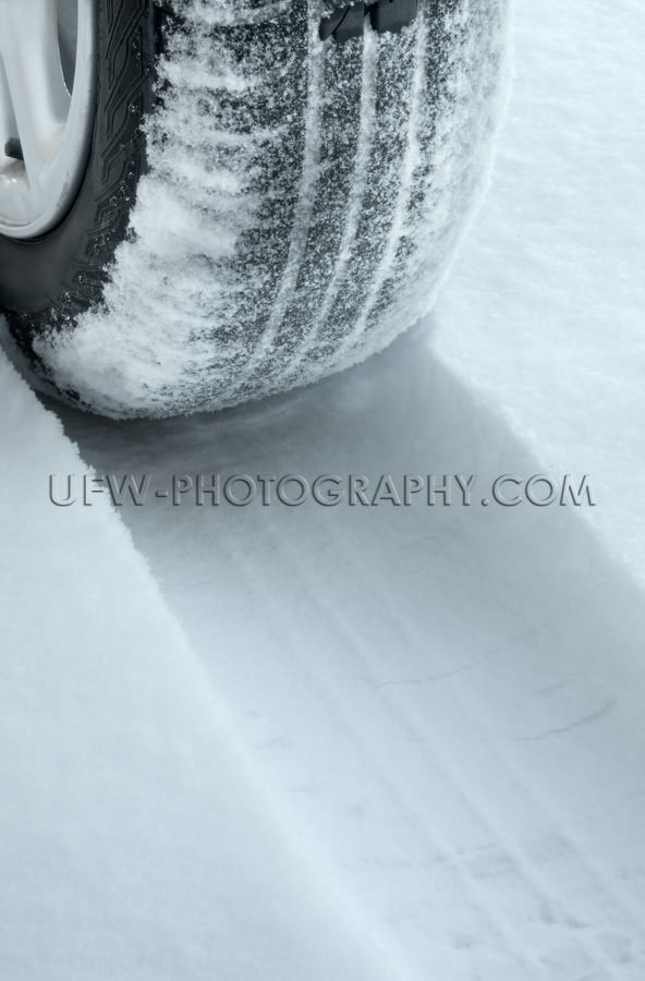 Winter tire on snow covered road Stock Image