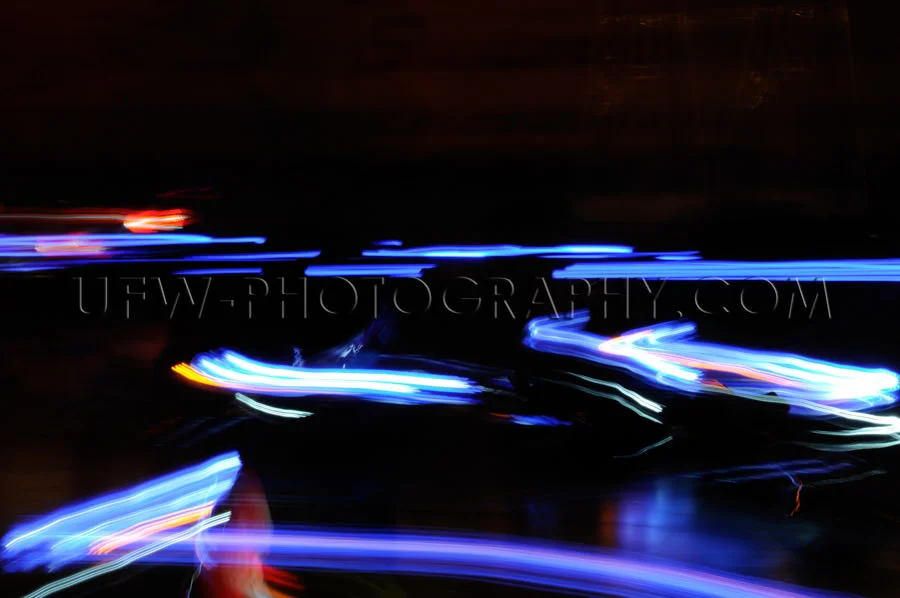 Abstract moving traffic lights red white blue motion blur Stock