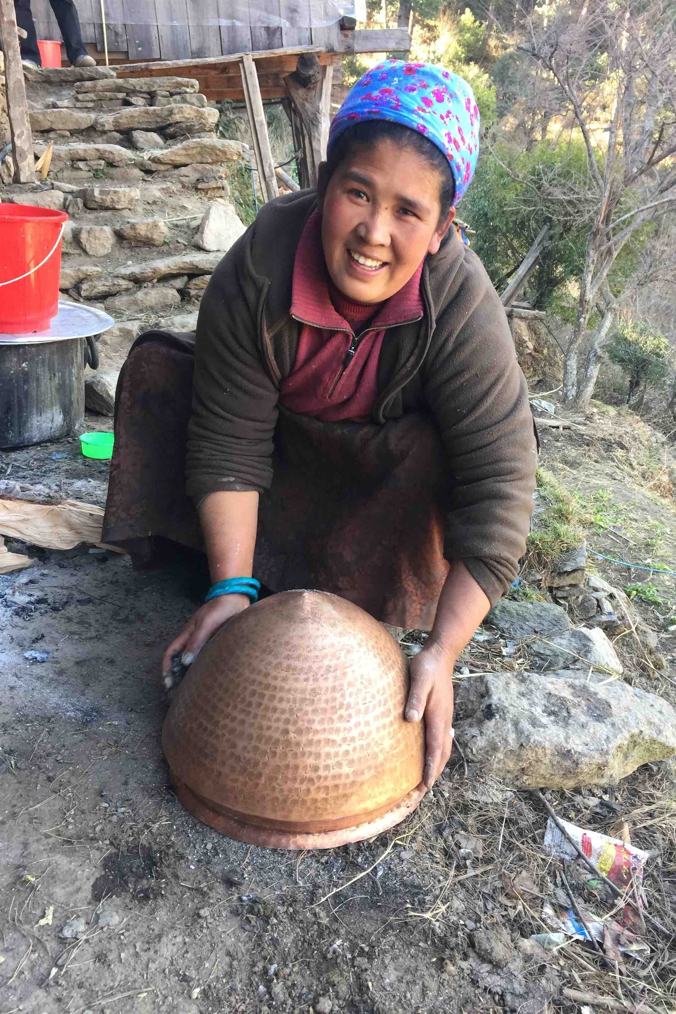 Bibi, who together with her husband, hosted Karen and Brice Hoskin in Nepal in 1992. Shown with her home still.