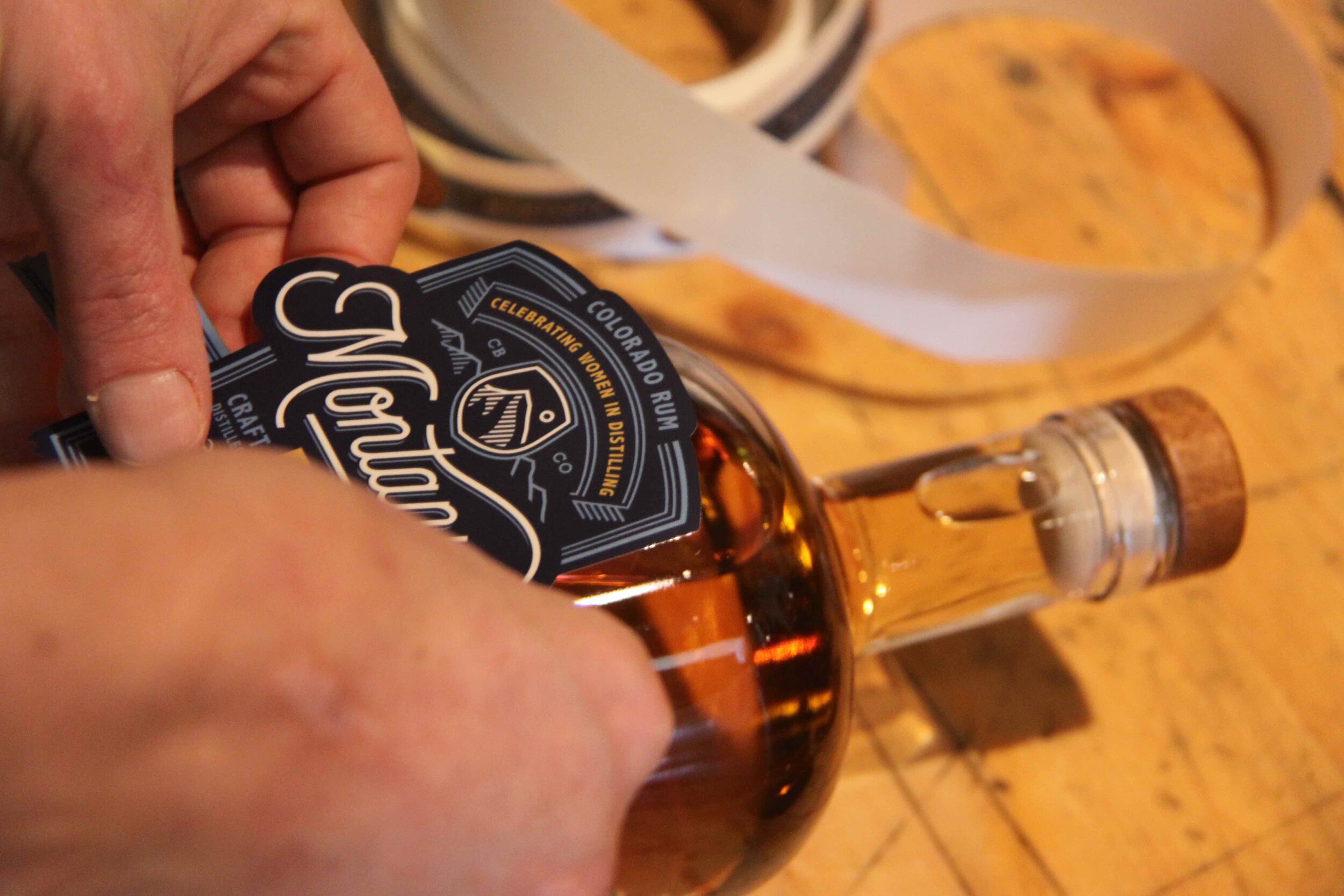 Placing a label on a bottle of Valentia (this won't always have to be done by hand).