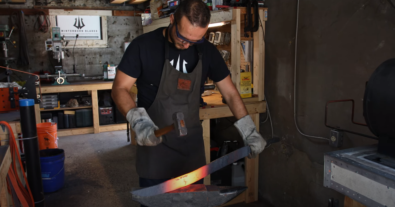 Winterborn-Blades-Steve-Karakostas-Bladesmith-Swordsmith-Tempering-Hot-Sword-on-Anvil.PNG