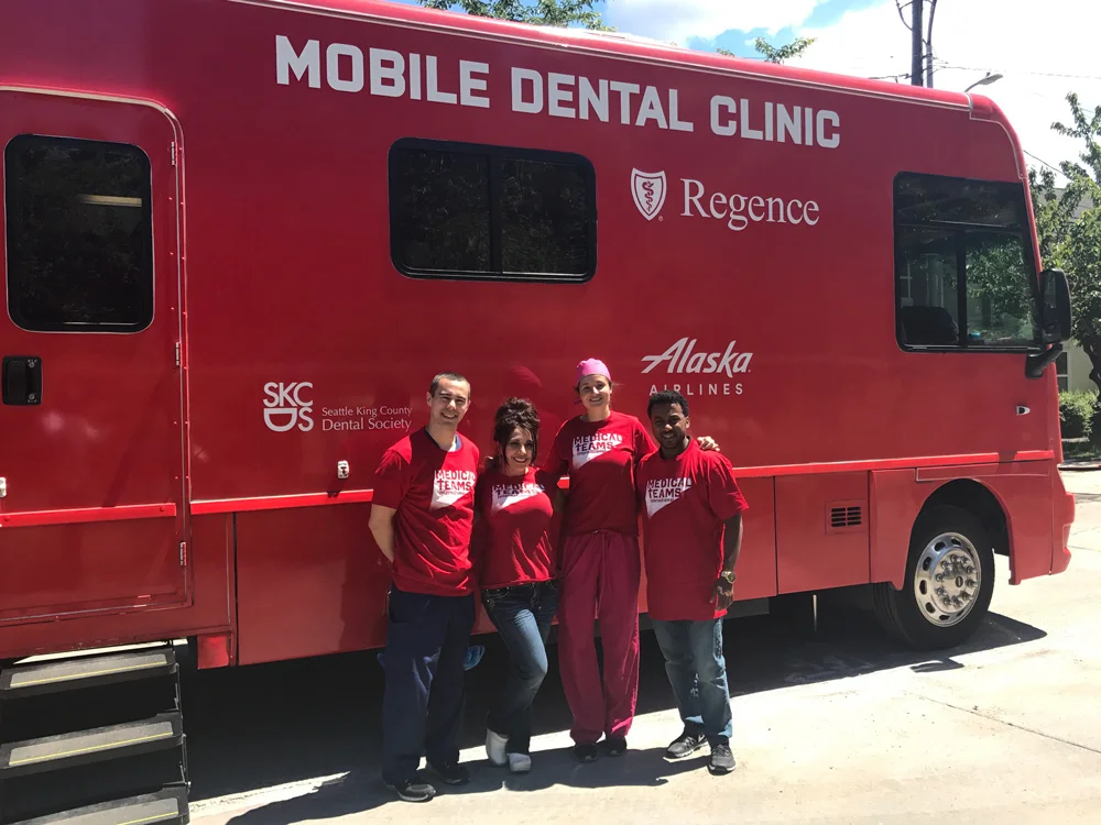 Dr. Suzuki and other volunteers outside a local mobile dental clinic treating the underserved in Seattle / King County.