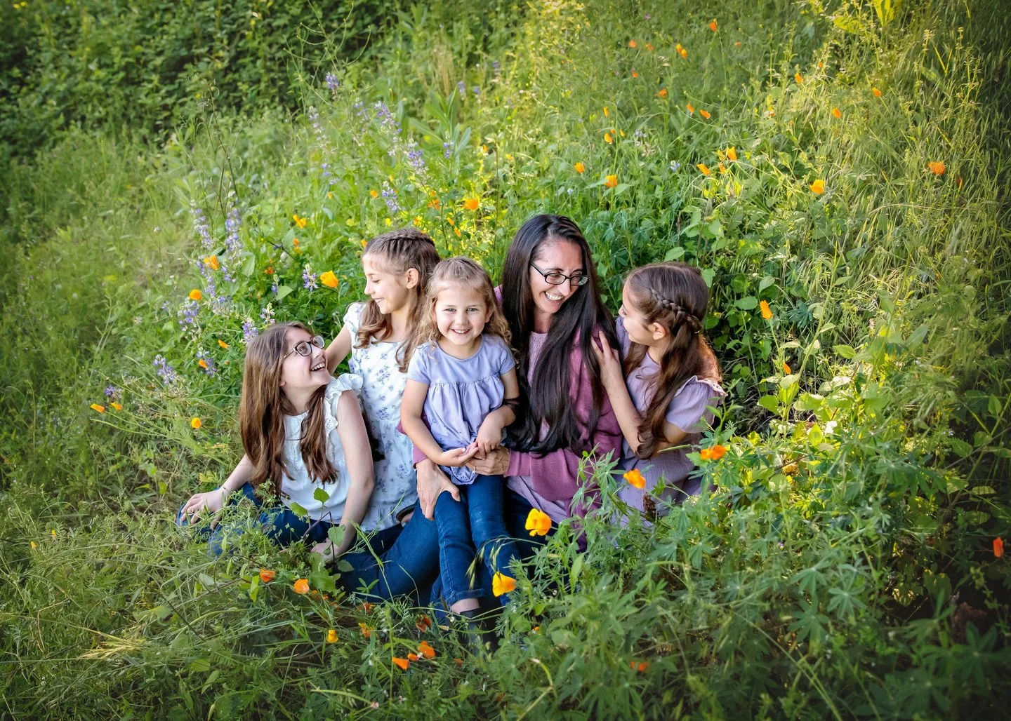When you have a secret garden of giggles, who needs a bouquet? I knew this location would be prefect for this mama and her girls. This lovely crew was all smiles in a sun-kissed field dotted with cheerful orange poppies. The way they huddled together