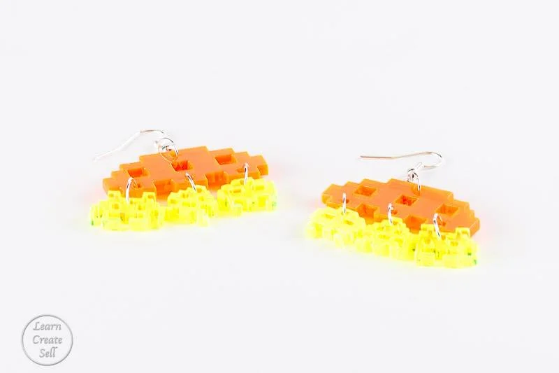 Retro vintage gaming inspired laser cut 8 bit graphic Jewellery Earrings. Cute, simple, iconic and instantly recognisable. Orange and green coloured.