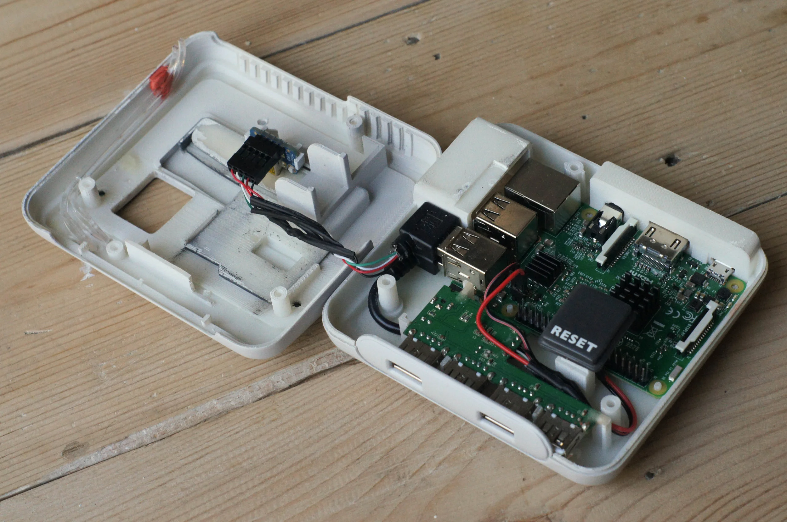 A single USB port is routed to a hub at the front, with a second USB port converted to a mini USB and routed to the top of the case. Ethernet and the remaining 2 USBs are still accessible from the side. The HDMI and power are at the rear of the case. Solder-less header pins are used to provide connection for the the reset switch. Light pipes guide the LEDs from the board to the front-top of the case. Each cartridge has a mini to standard USB connection to plug in a small profile USB stick which hold the OS.