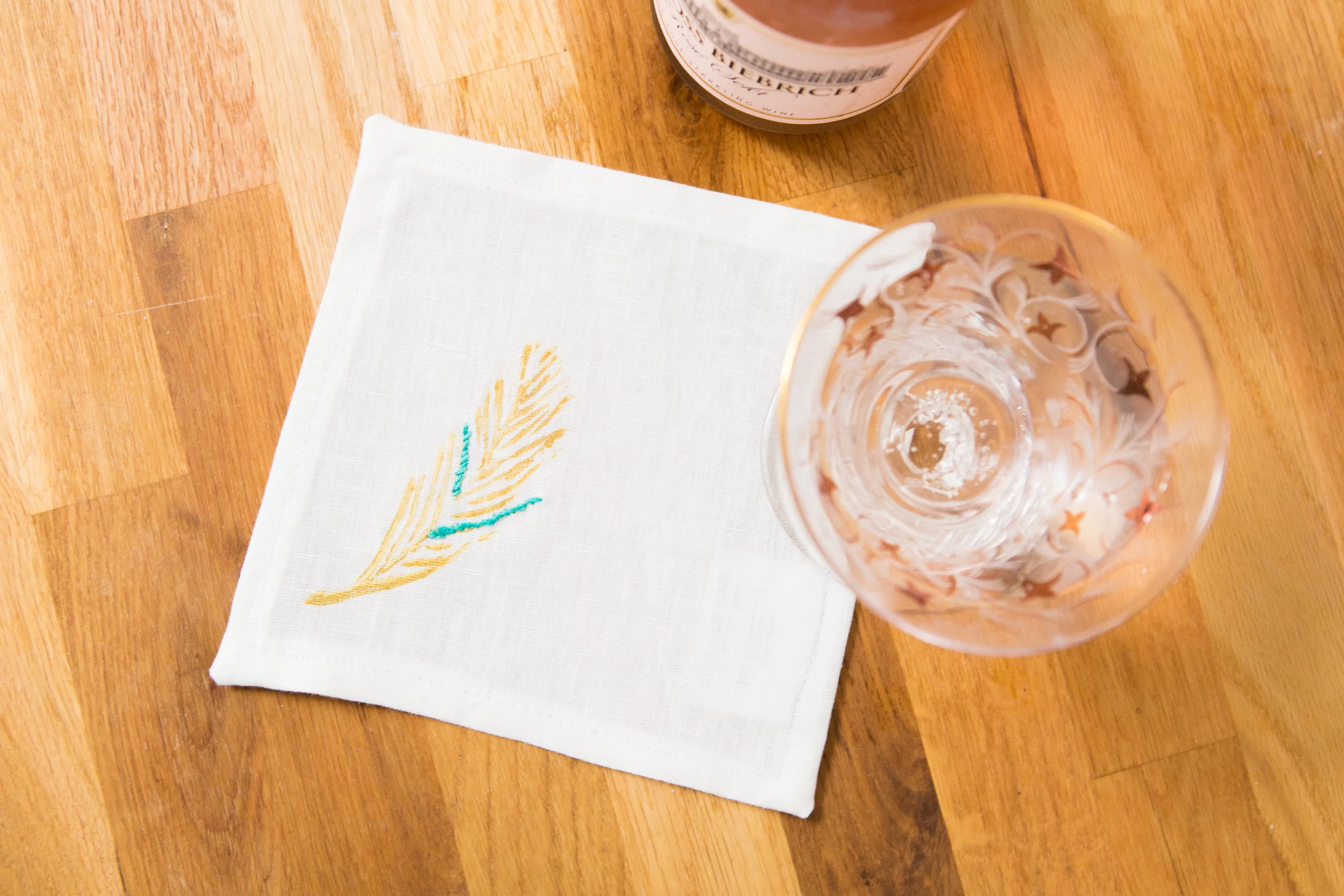 cocktail nap feather in gold embroidered on white.jpg