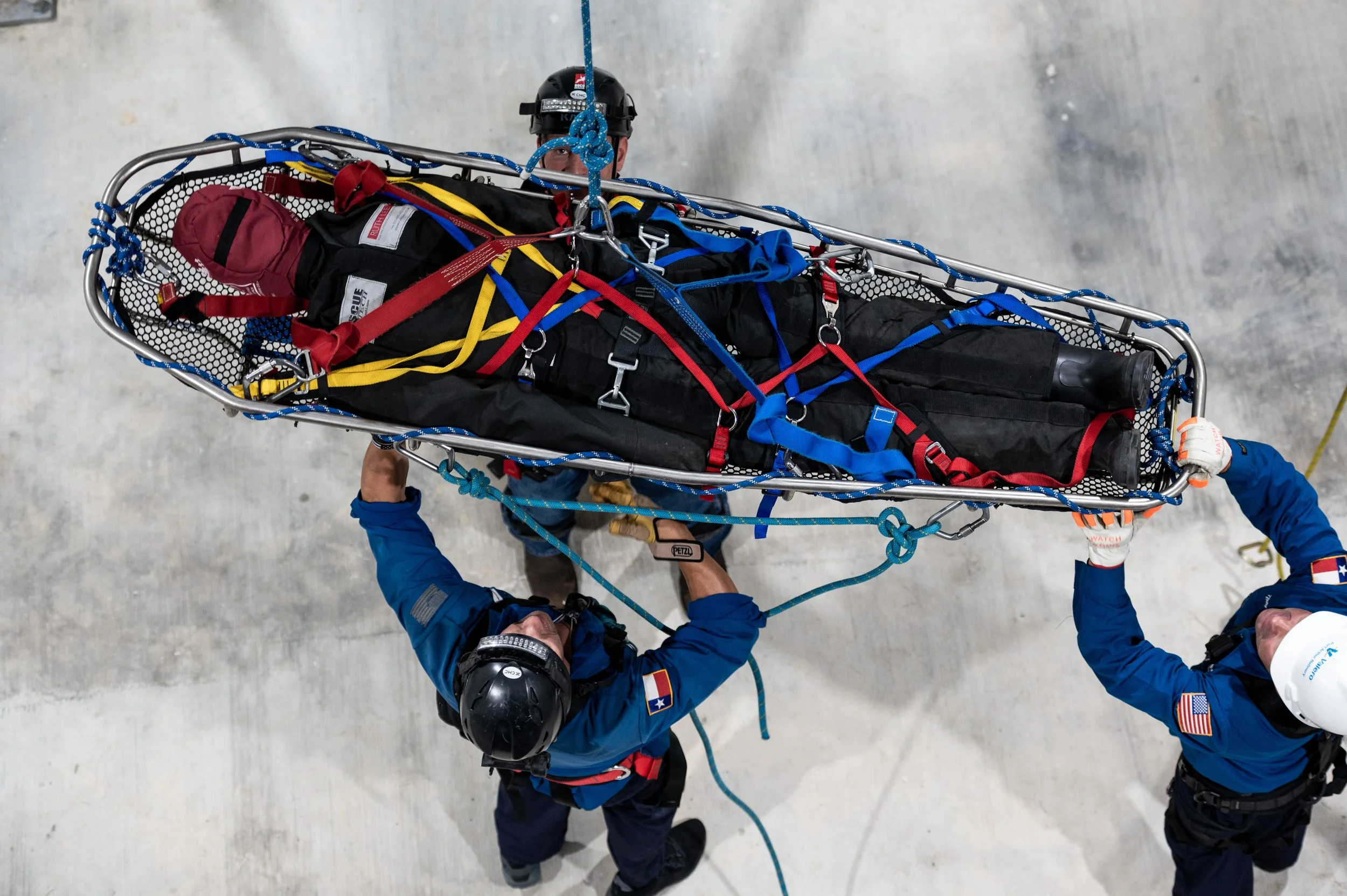 Two emergency rescue personnel transport a patient on a stretcher.