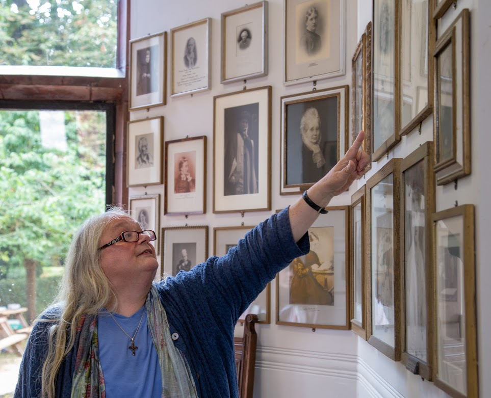 Alison points to portraits girton.jpg