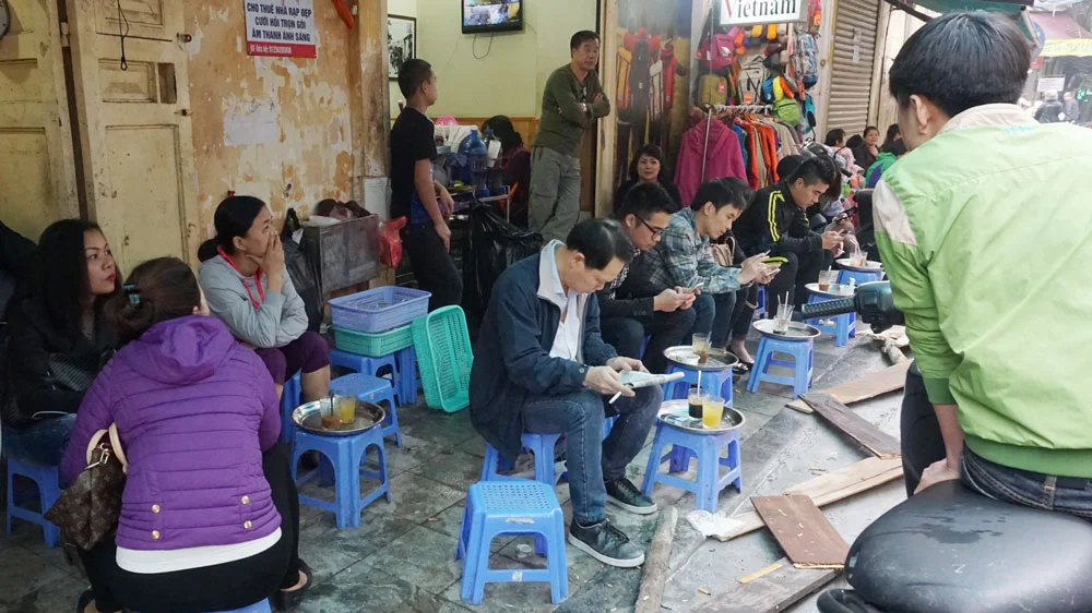 Eating on the sidewalks - Hanoi