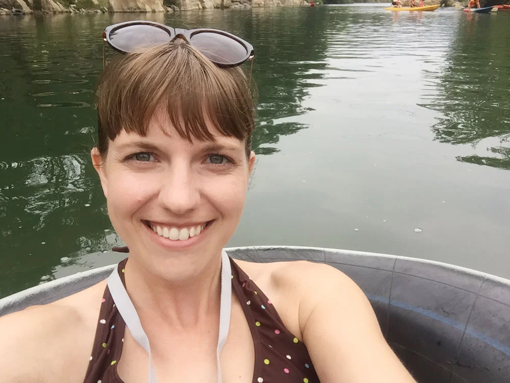 Tubing alone down a cold river, Vang Vieng