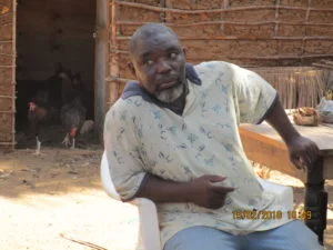 Mr.Juma in front of his poultry house