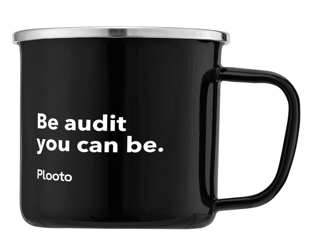 A black mug with white text reading "Be audit you can be." and the brand name "Plaato" on it.