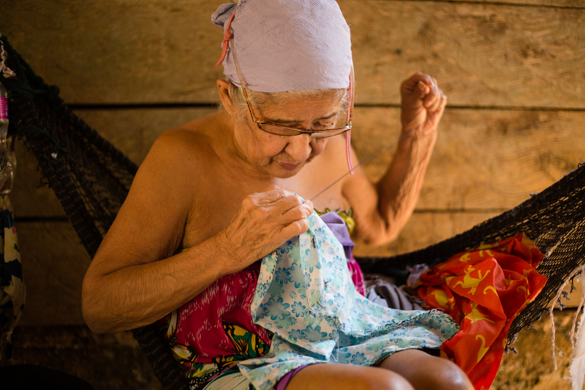 2019. Vita, the village elder, can no longer collect palm to bind for brooms. She now makes bags instead and sells them for $0.10.