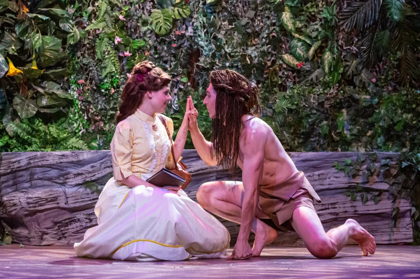 Jane (Katie Jackson) and Tarzan (Barret Harper) touch hands in a scene from Candlelight Dinner Playhouse’s “Tarzan.” (Courtesy of Candlelight Dinner Playhouse)