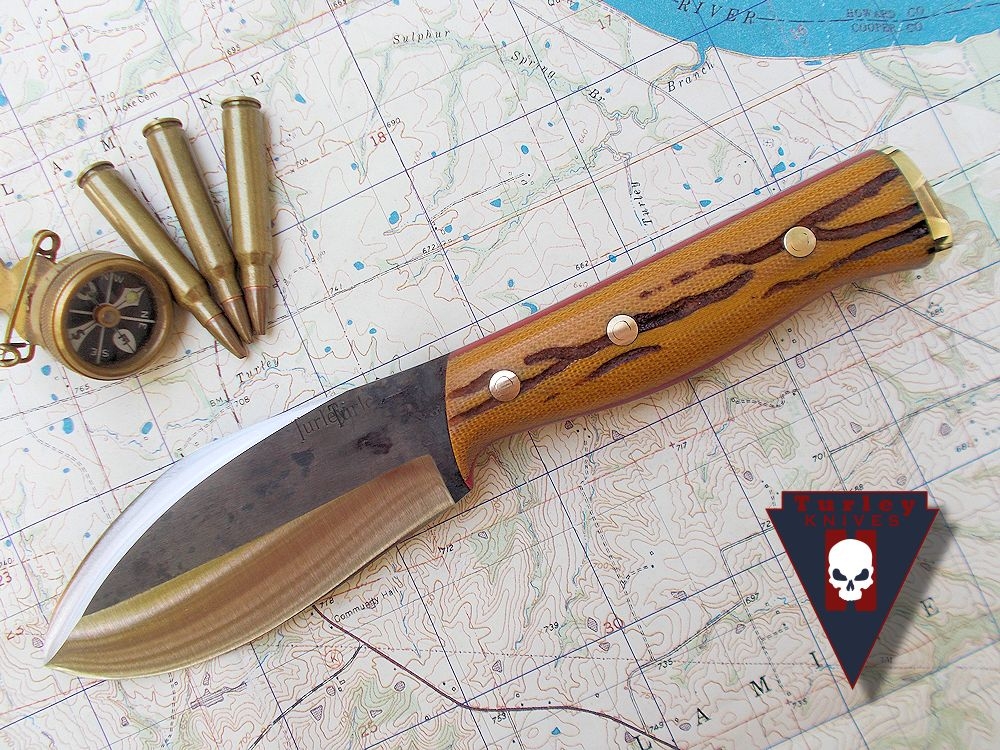 Natural canvas micarta. Hand jigged scales