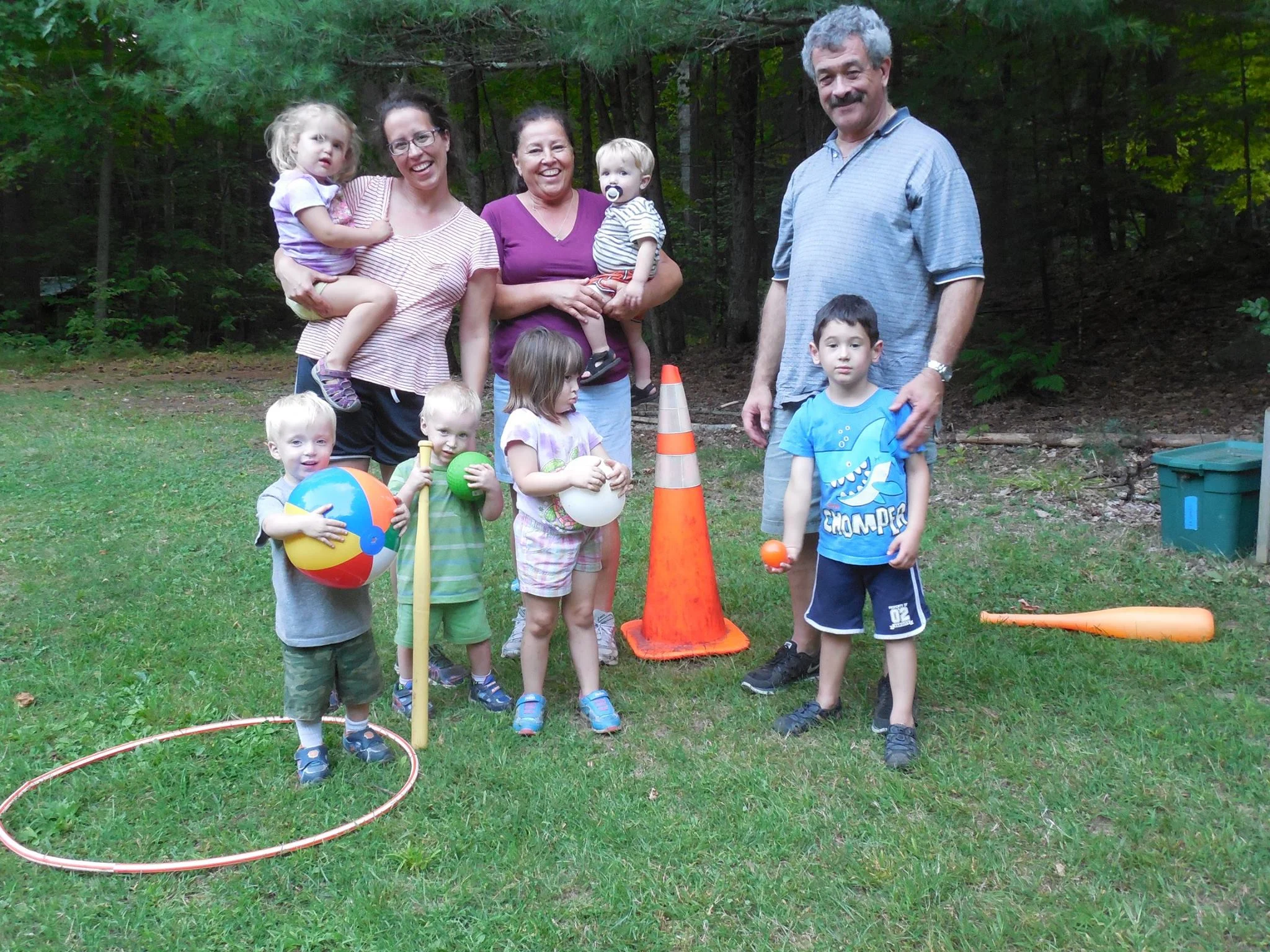 adults with children posing with toys