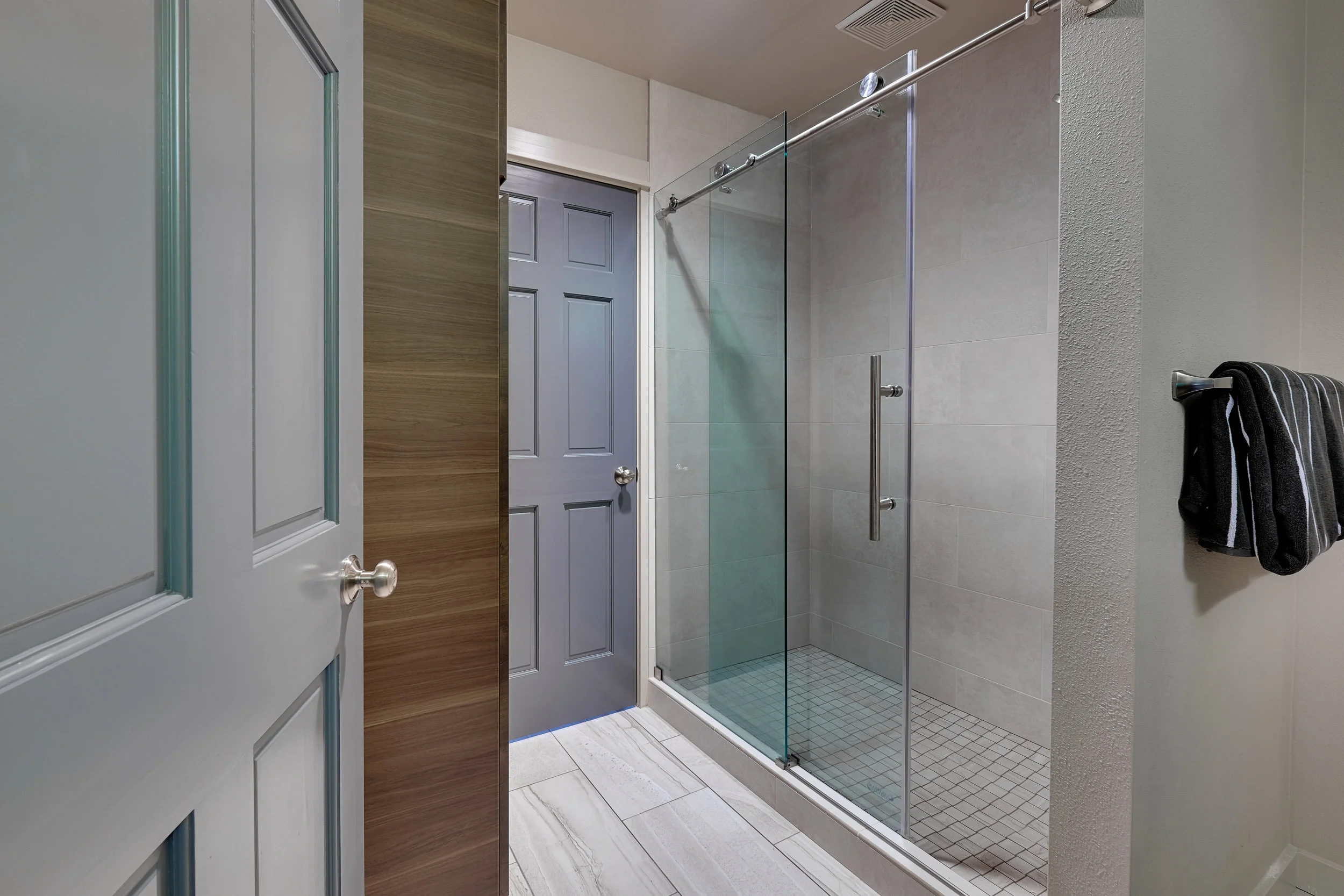 opened up walls to create one large bathroom with walk-in shower and linen closet