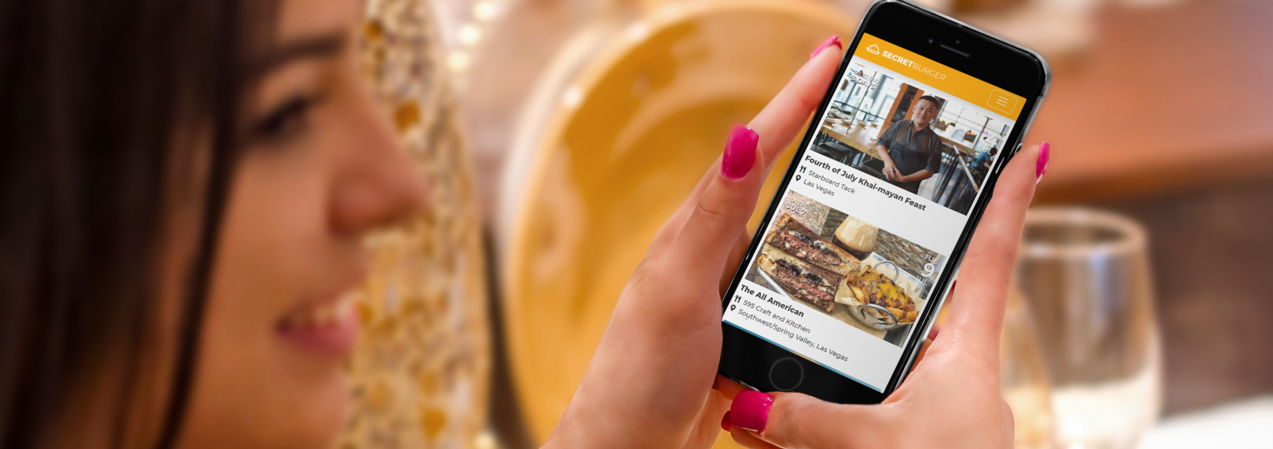 mockup-of-a-woman-holding-an-iphone-6-at-a-restaurant-wide.png