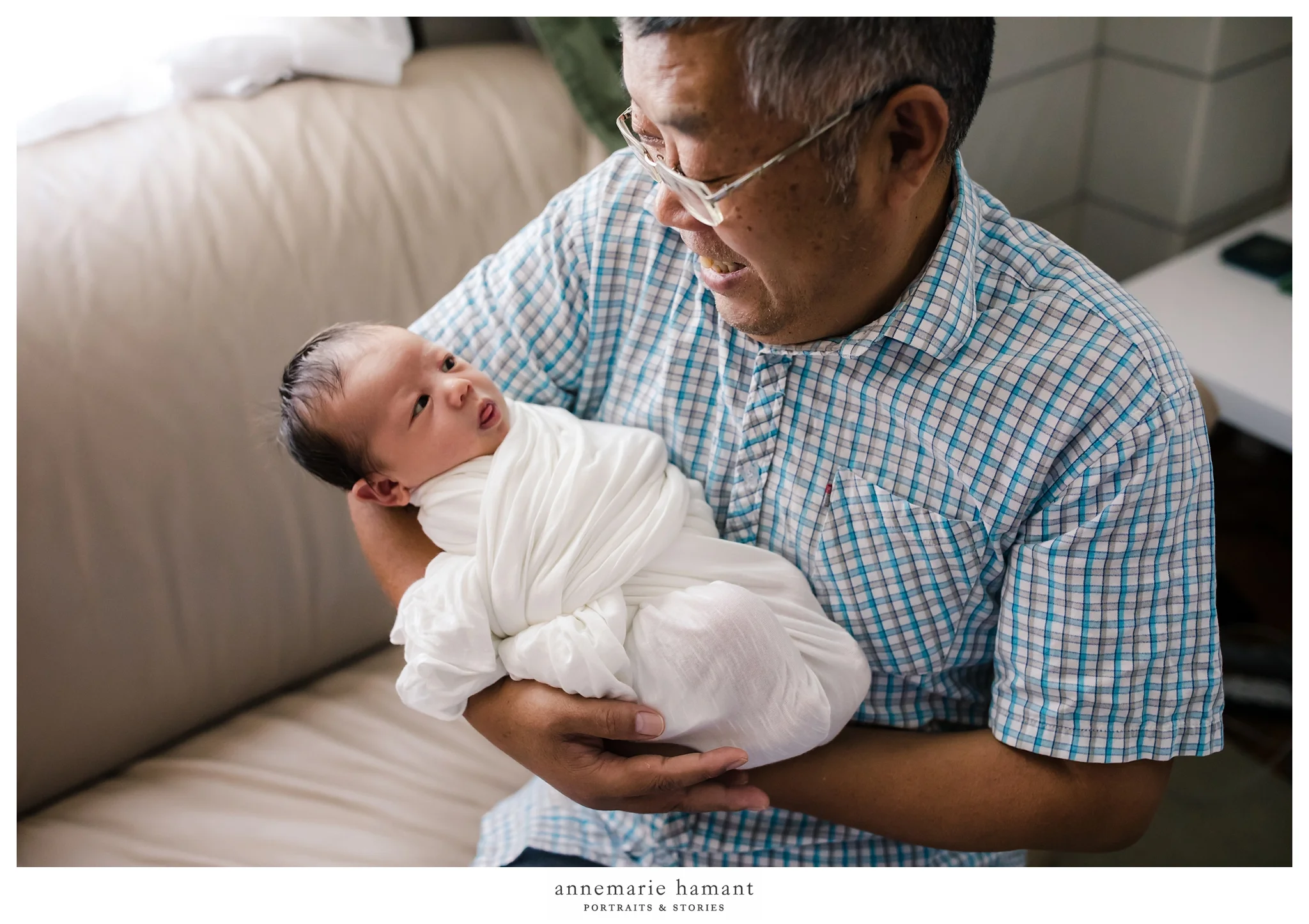grandpa holding newborn baby