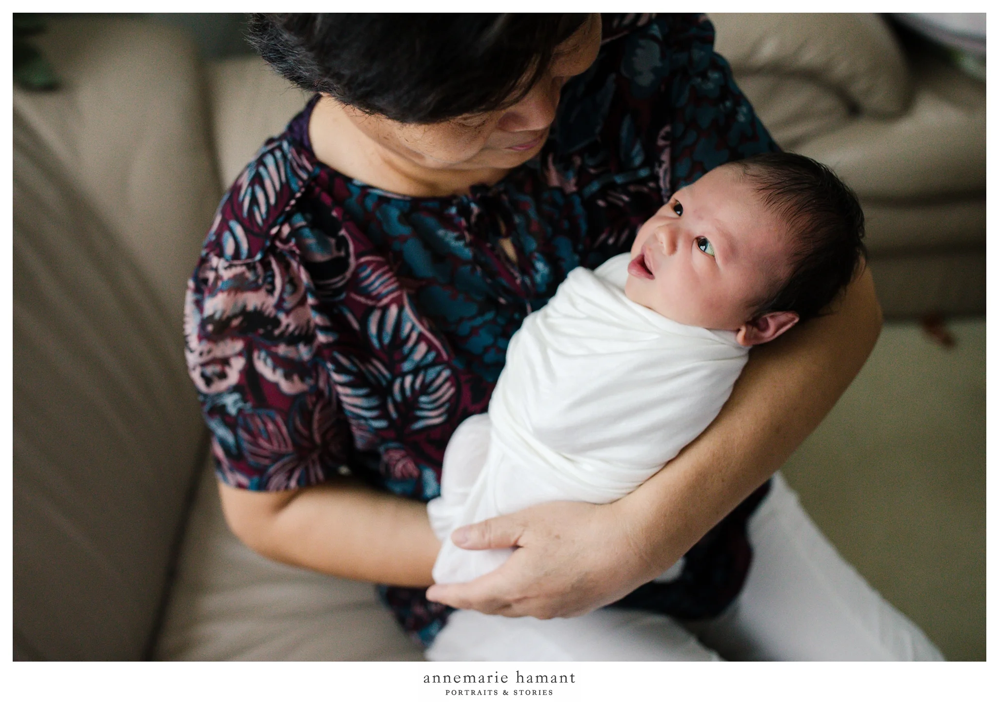 grandma holding newborn baby