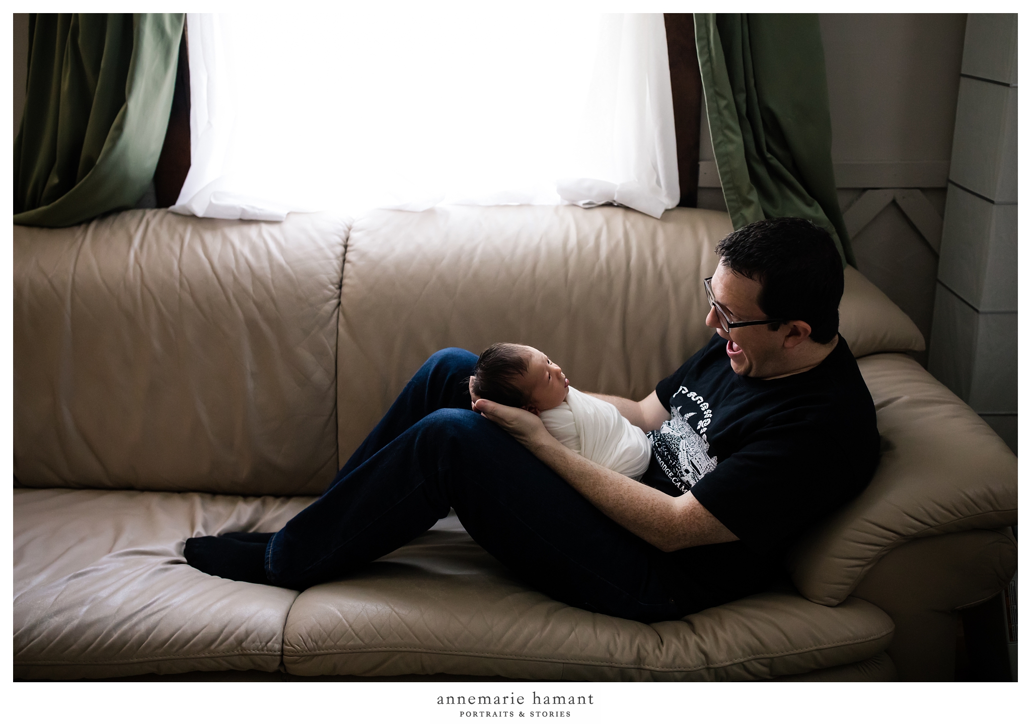 dad and newborn baby on couch