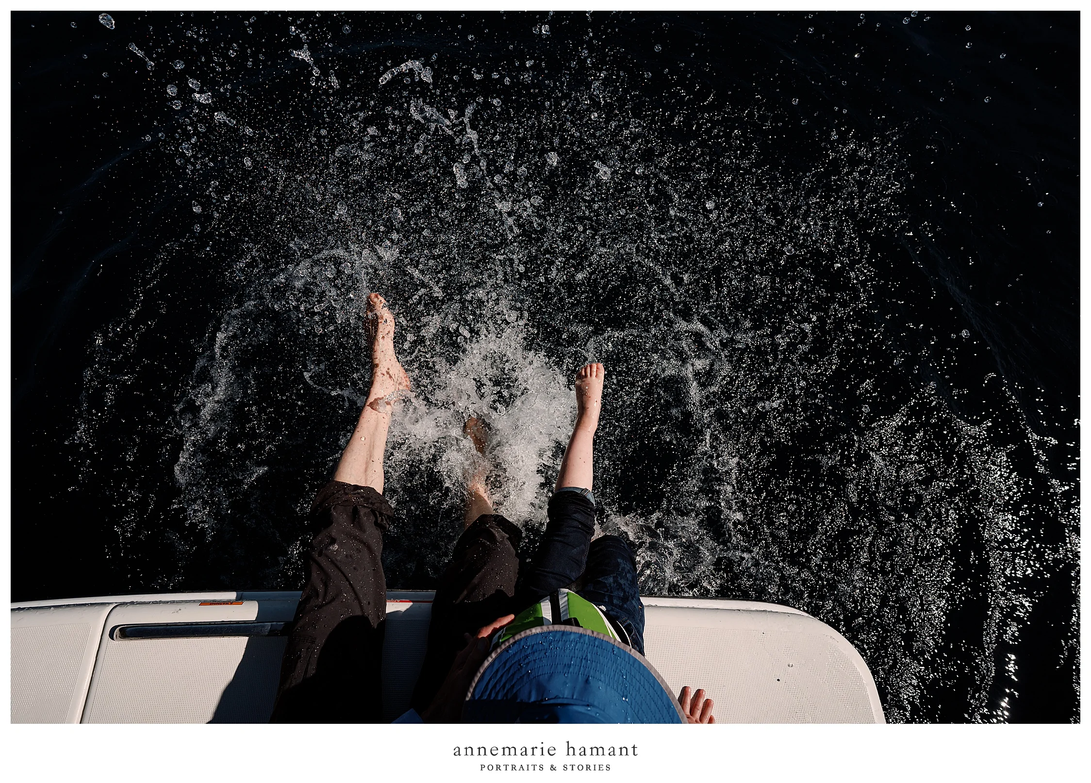 grandfather and grandson splash in water on boatride.