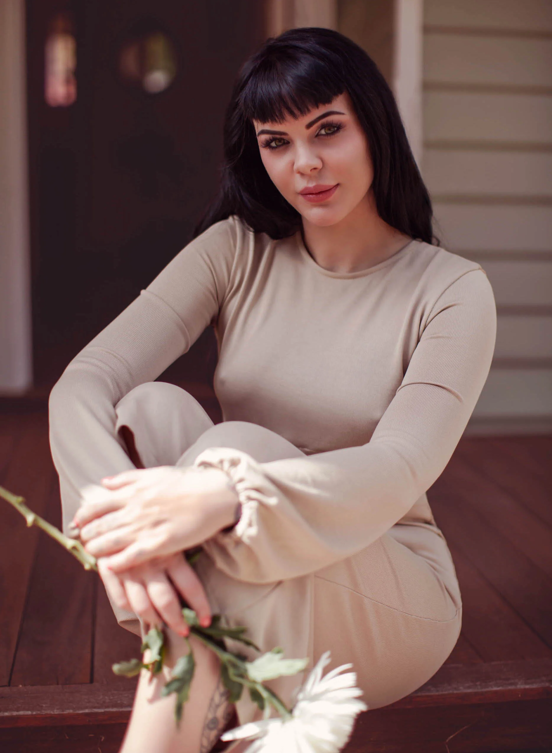 black-haired-escort-sweetly-holding-a-white-flower.jpg