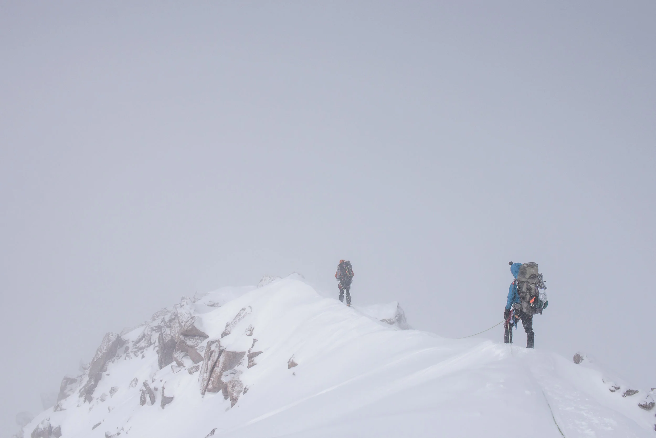 Climbing across the ridge in whiteout conditions.