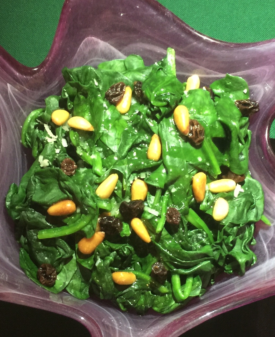 The spinach is only barely wilted so the leaves remain slightly separated.