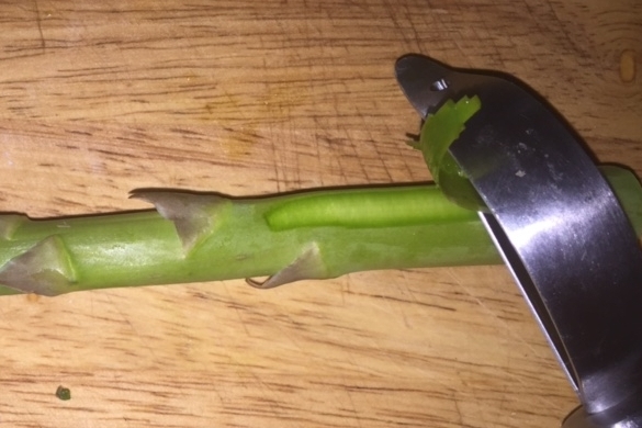 To peel, lay spear flat and run carrot peeler toward stem end. Turn and peel all the way around.