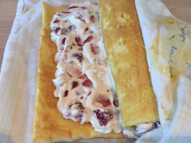 Using towel to help you, roll cake up around filling. Slide roll onto a sheet of heavy foil and place seam side down. Wrap in foil and refrigerate until chilled.. 