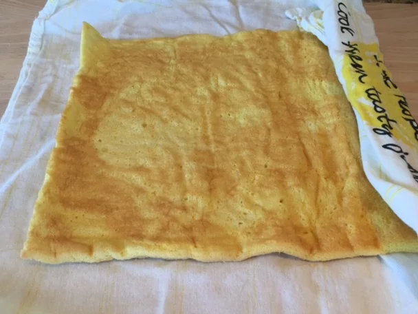 Invert cake onto towel sprayed with non-stick coating. Roll cake into towel. Set aside until cool. 