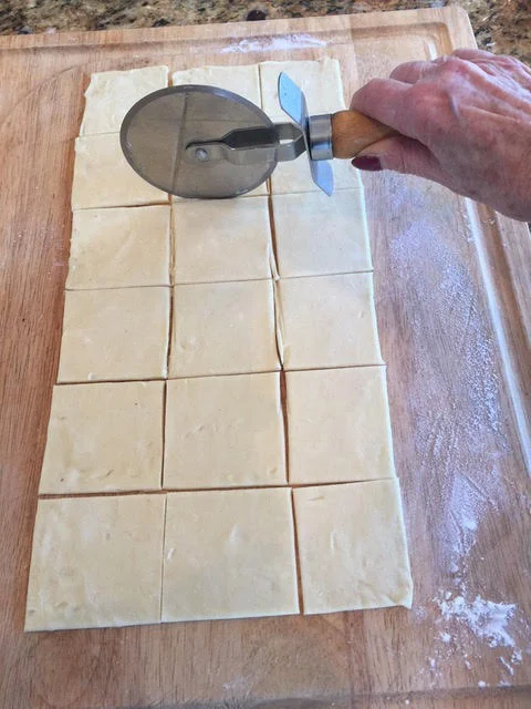 I prefer a pizza cutter to cut the dough into 2 1/2-inch squares.