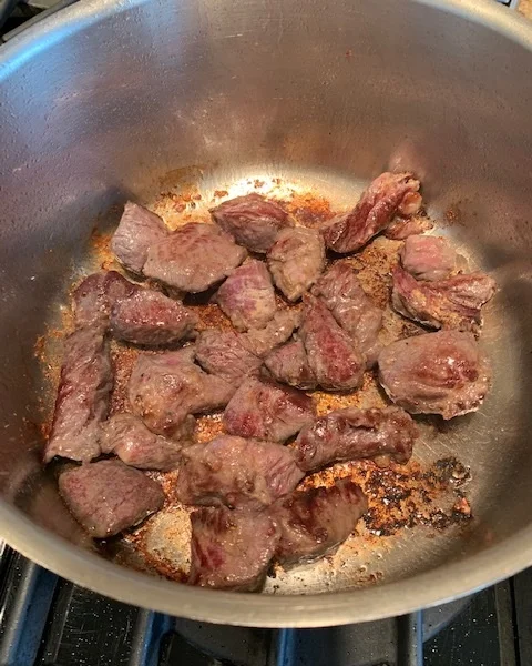 Sear the meat on high, but if the drippings on the bottom begin to burn, immediately reduce heat to medium.
