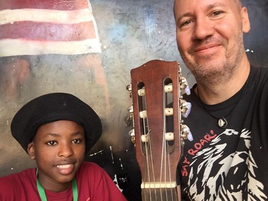 Nate Silas Richardson and his new friend, Charles, take a break from playing music together at the skate park near Shangilia Orphanage in Kenya.