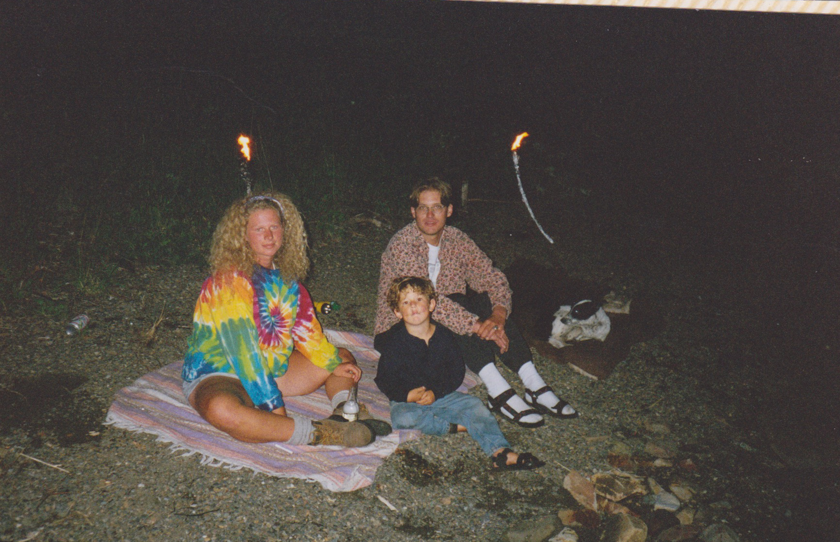M tie die sitting by tiki torches.jpeg