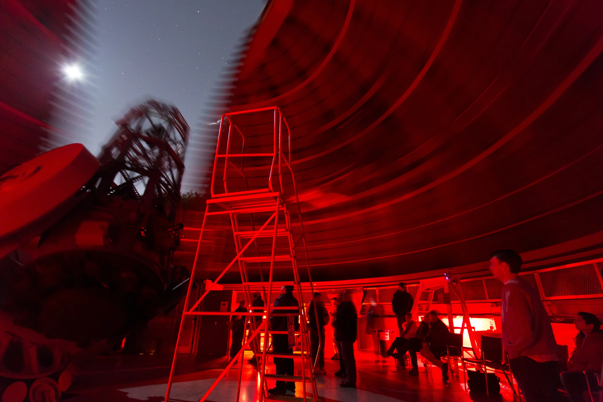 The dome rotates as the 60-inch telescope is repositioned. The ladder remains steady in its designated safety area.