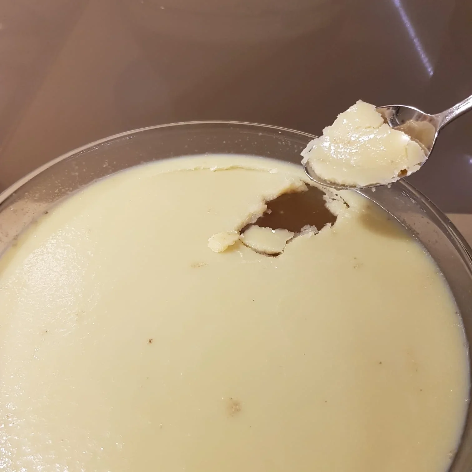 Cooled bone broth showing natural collagen-rich fat layer on top, ready to store or reheat.