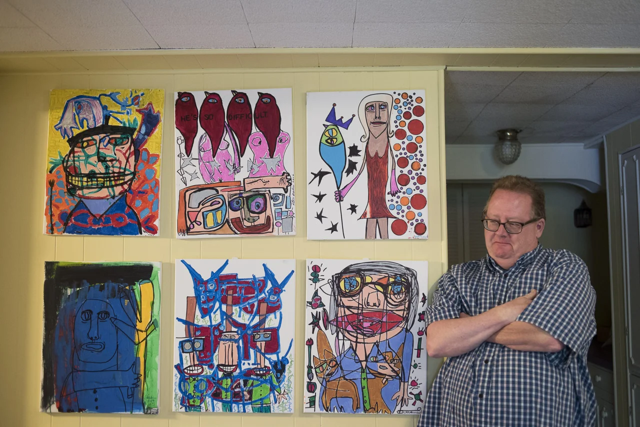 Denton beside some of his various canvases.