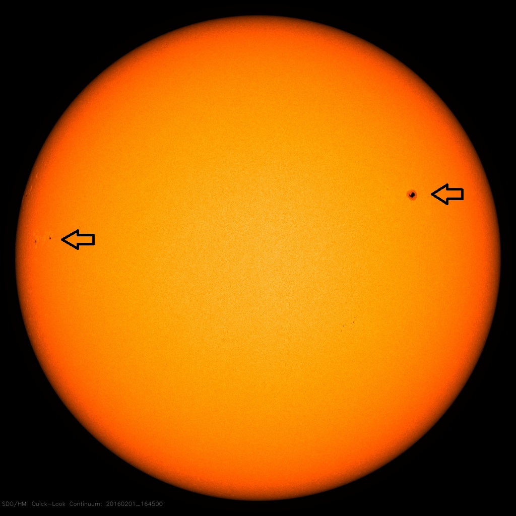 Current solar image with only two visible sunspot regions (arrows); courtesy NASA