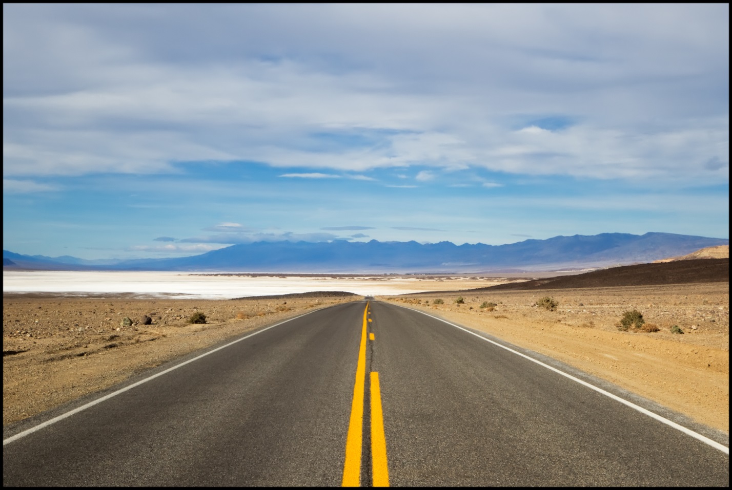Asphalt roadway near the salt flats of Death Valley National Park