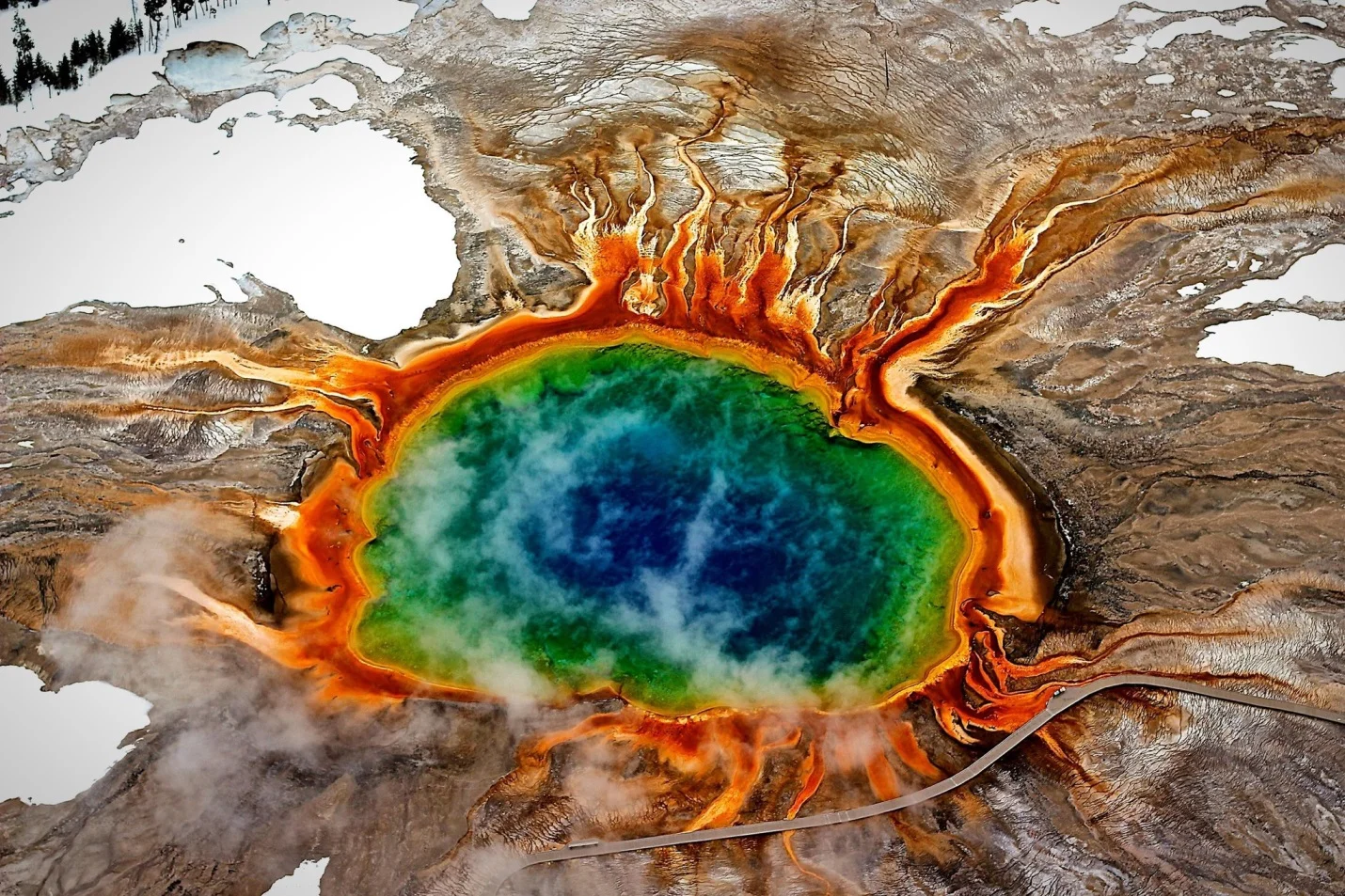 The Grand Prismatic Spring in Yellowstone National Park, a large hot spring known for its vibrant colors. Beneath the park is a powerful supervolcano which drives the spring and other geological activity. Credit for image: Marie-Louise Mandl/EyeEm, via Getty Images; NY Times