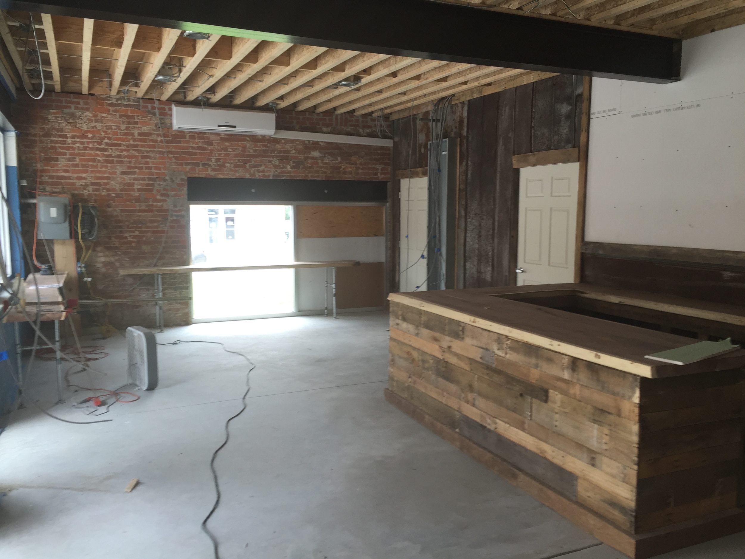  1/2 of our picture window is in place, overlooking Main St., with a long walnut bar in front. 
