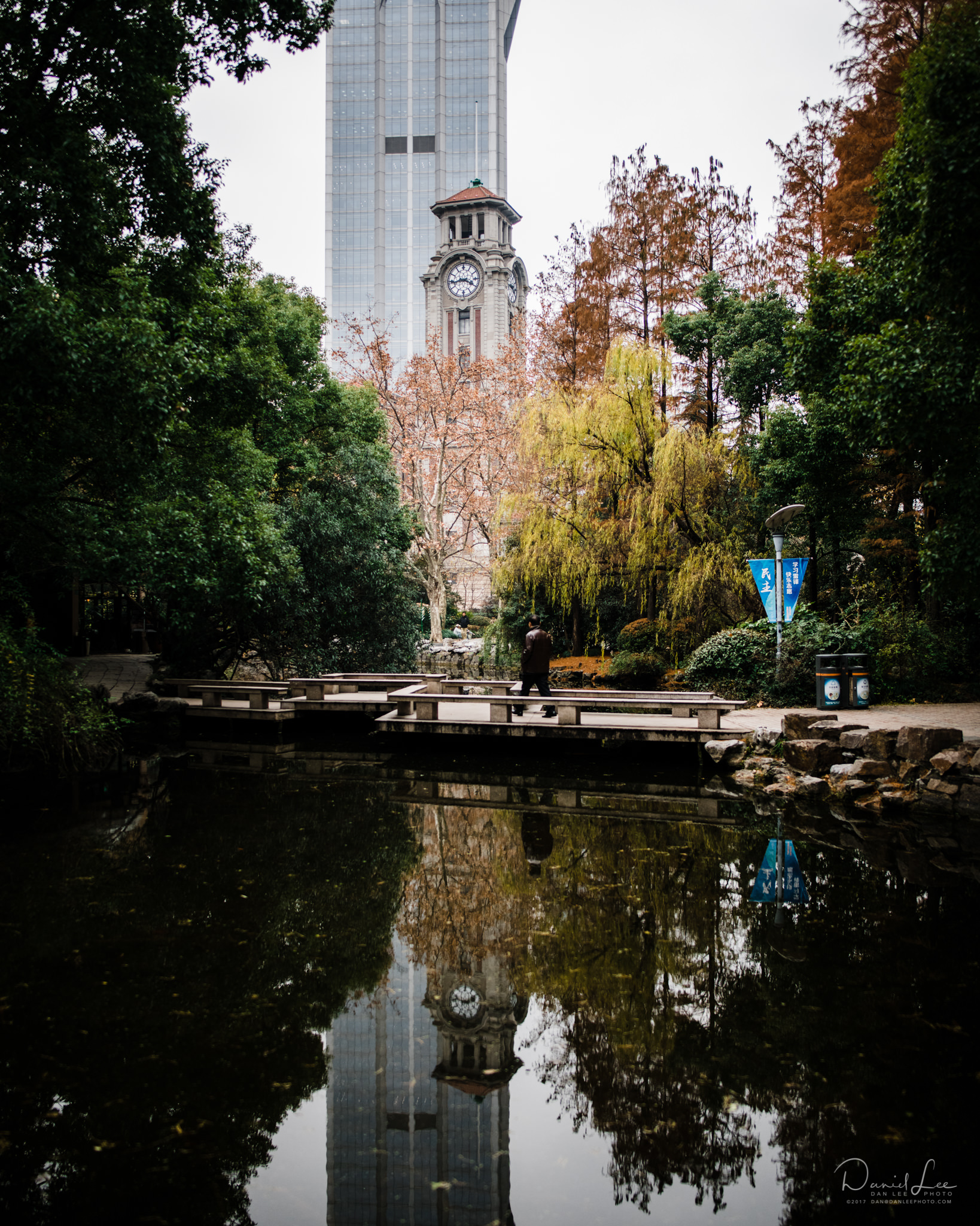 The reflection of the clock tower of the Jiu Jiang Building Management Office calmly rests on Baihua Pond in Shanghai People's Square. Shanghai, China.&nbsp;Photo by Daniel Lee. 