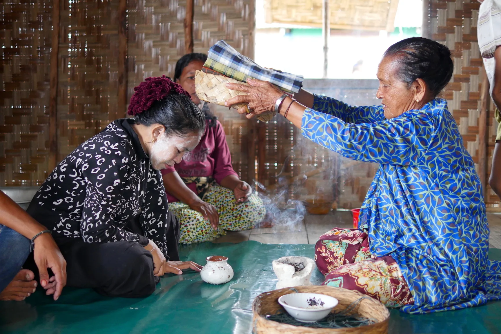 Bajau elder, or sandro, Mbo Sayatina performs a ritual for an expectant mother after making offerings to the sea.